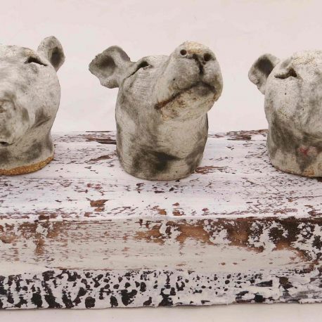 ceramic dogs, whippet heads on woodblock